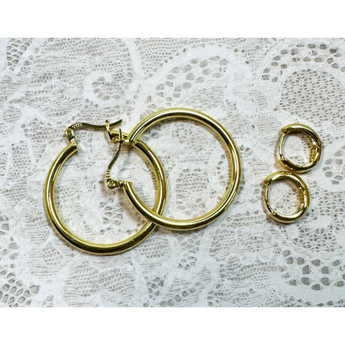 A Pair of Gold Hoop Earrings  One 1 1/4 Inch and One Huggies 3/8 Inch E299
