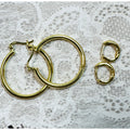 A Pair of Gold Hoop Earrings  One 1 1/4 Inch and One Huggies 3/8 Inch E299