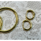 A Pair of Gold Hoop Earrings  One 1 1/4 Inch and One Huggies 3/8 Inch E299