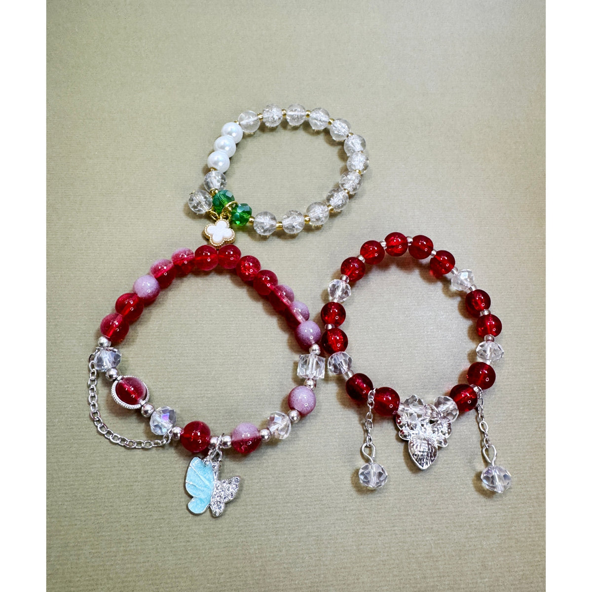 Set of 3 Stretch Bead Bracelets Butterfly Clover Acorn Charms  Description: